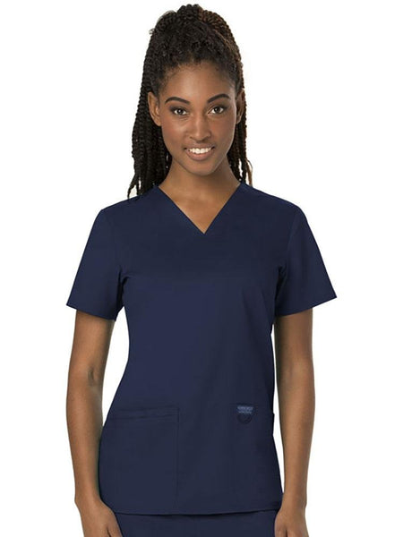 Surgical Technician wearing Cherokee Workwear Revolution women's V-Neck Scrub Top in navy size medium